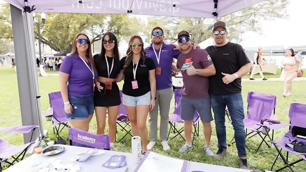 The Gravity Roofing team under their branded tent at Brunch in the Park 2025 in Orlando, Florida, connecting with the local community