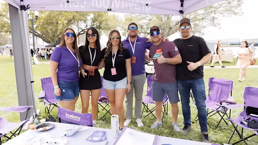 The Gravity Roofing team under their branded tent at Brunch in the Park 2025 in Orlando, Florida, connecting with the local community