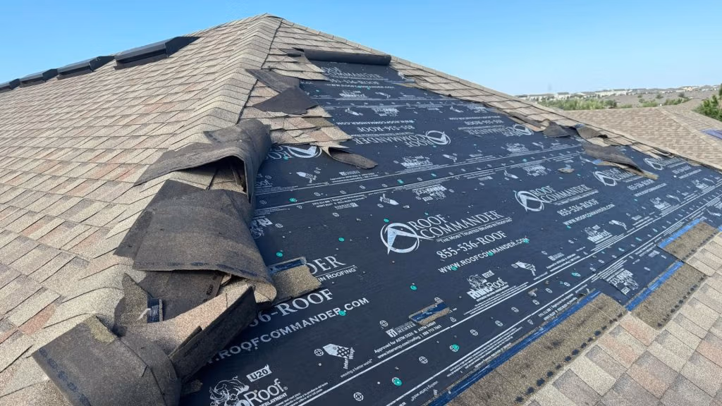 Roof showing missing shingles and underlayment after storm damage in Central Florida