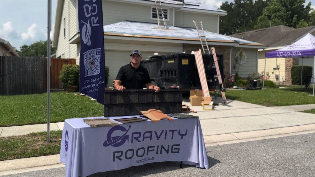 Gravity Roofing team member showcasing roofing materials during a roof replacement in Central Florida