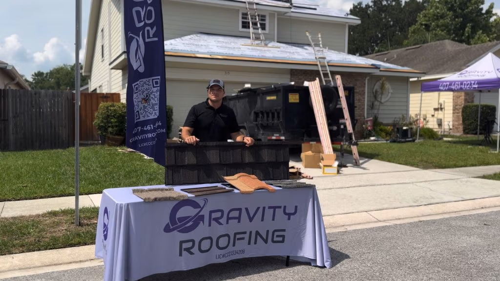 Gravity Roofing team member showcasing roofing materials during a roof replacement in Central Florida
