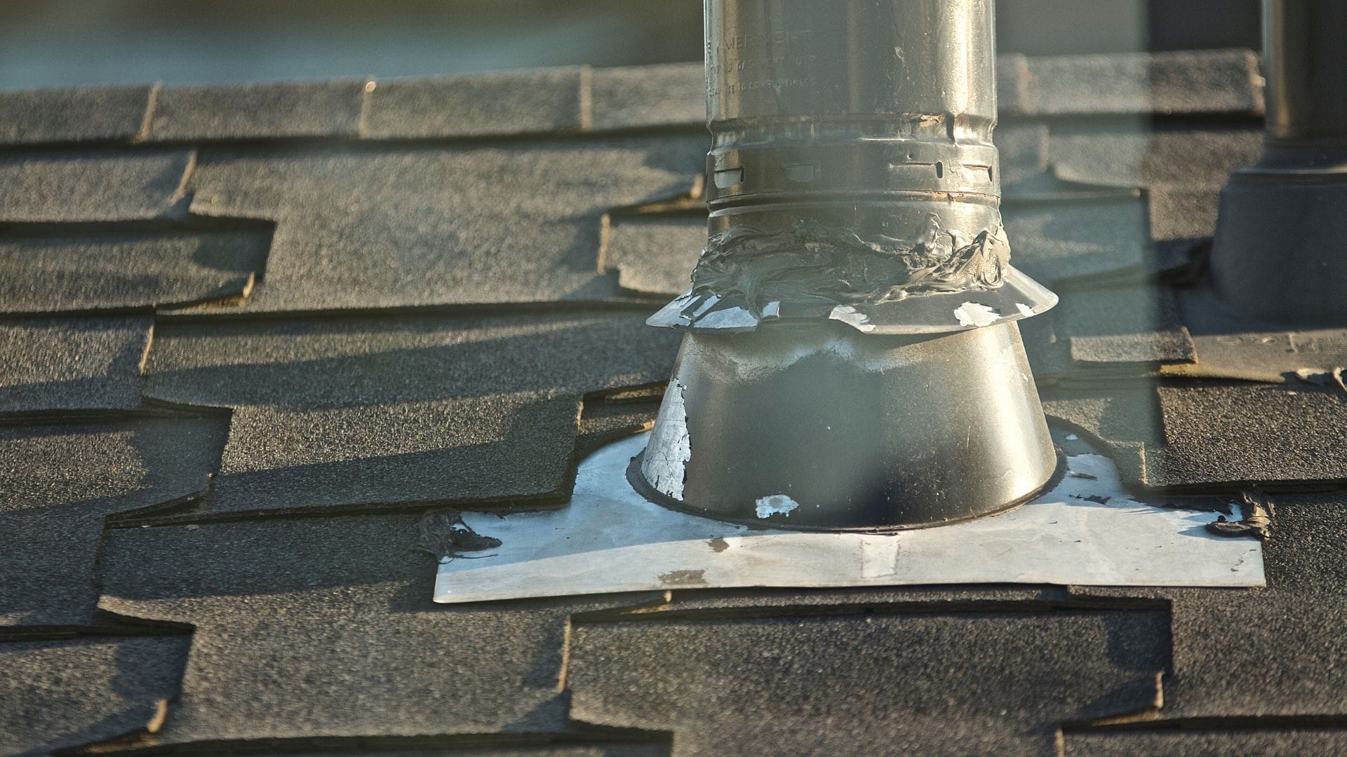 Roof Vent Leak repair on a Central Florida home with a roofer inspecting a vent boot