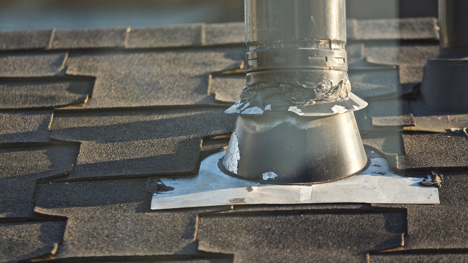 Roof Vent Leak repair on a Central Florida home with a roofer inspecting a vent boot