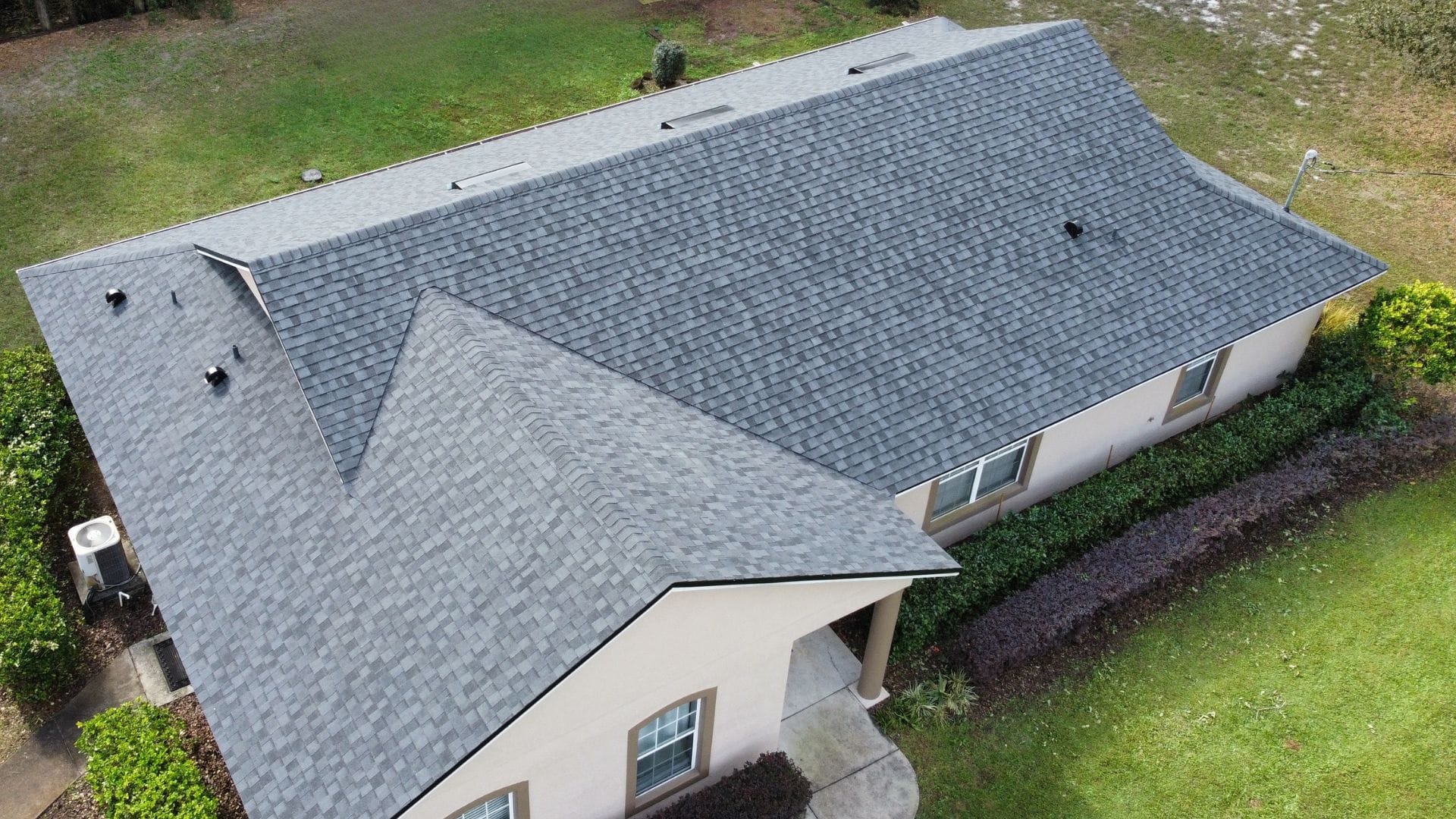 Roof inspection Clermont — roofing expert inspecting shingles on a Florida home after storm season.