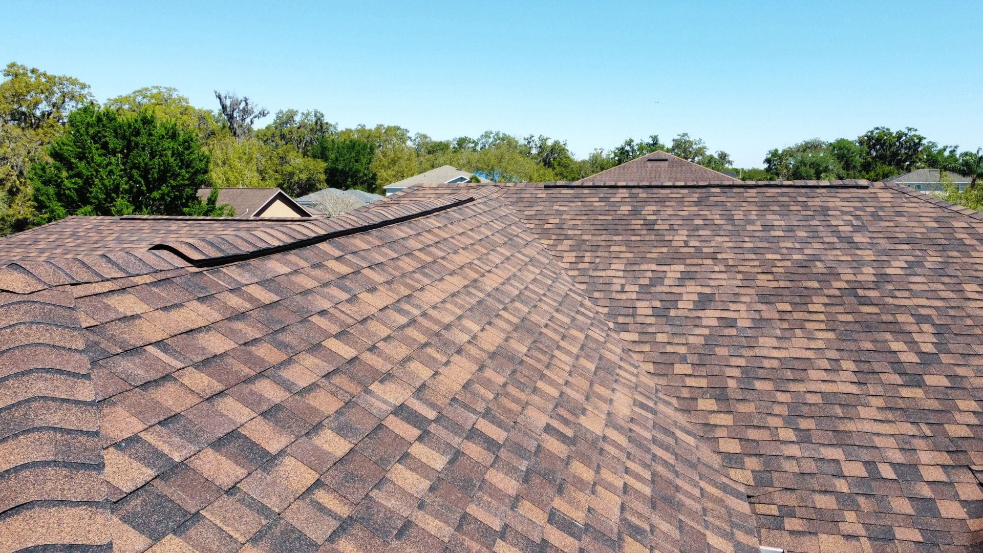 Roof inspection Eustis — roofing expert inspecting shingles on a Florida home after storm season.