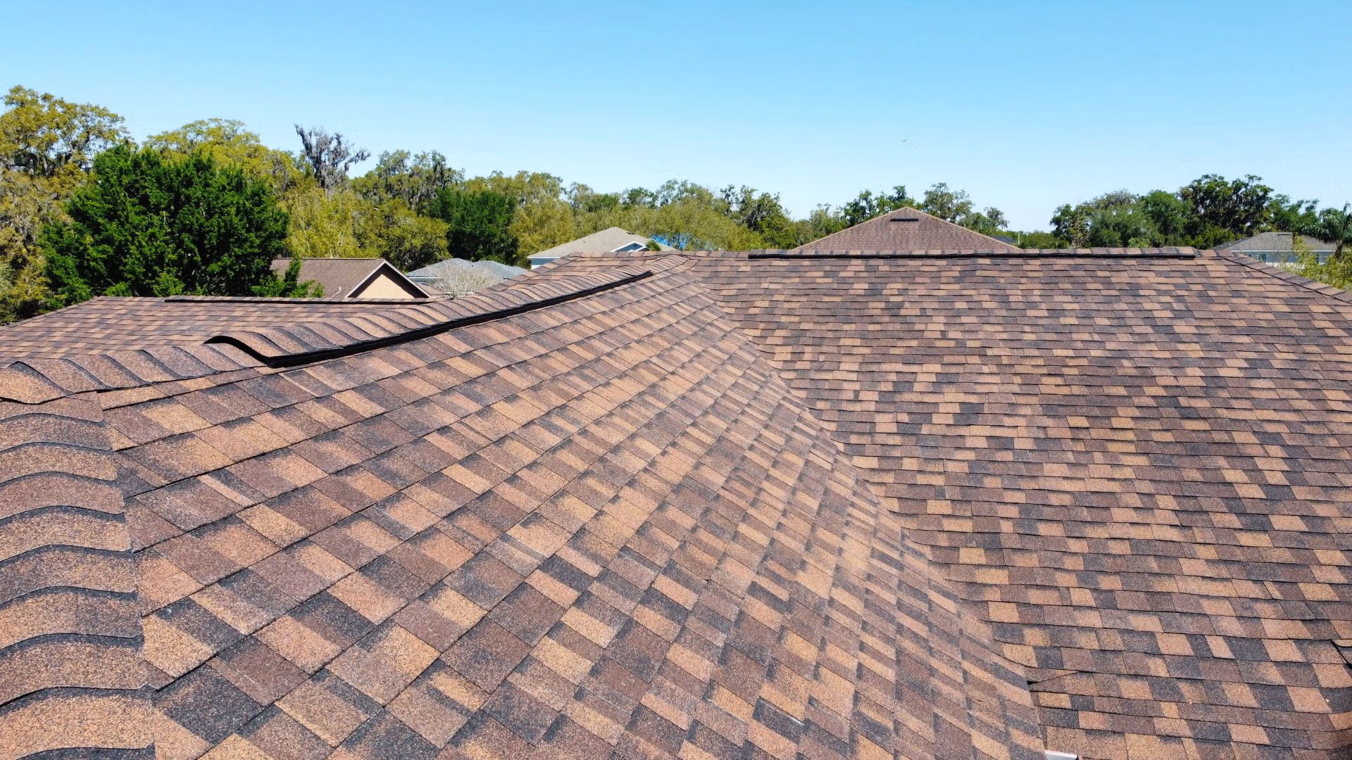Roof inspection Eustis — roofing expert inspecting shingles on a Florida home after storm season.