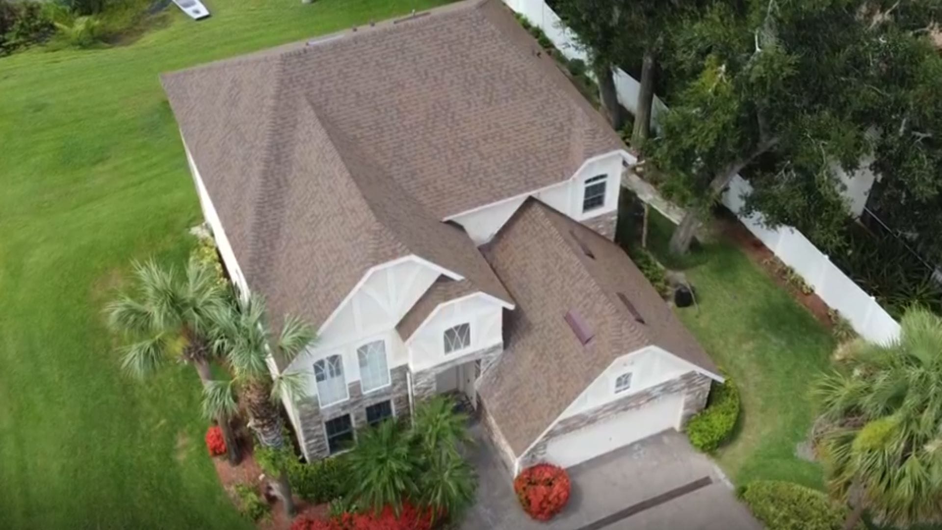 Roof inspection Ocoee — roofing expert inspecting shingles on a Florida home after storm season