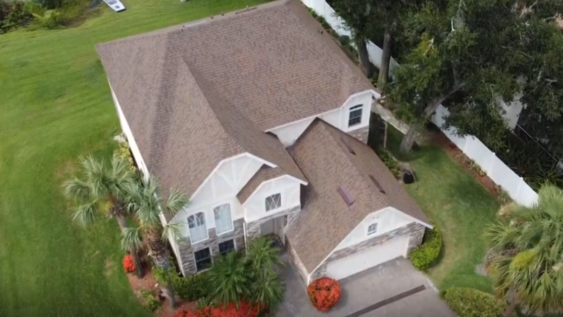 Roof inspection Ocoee — roofing expert inspecting shingles on a Florida home after storm season