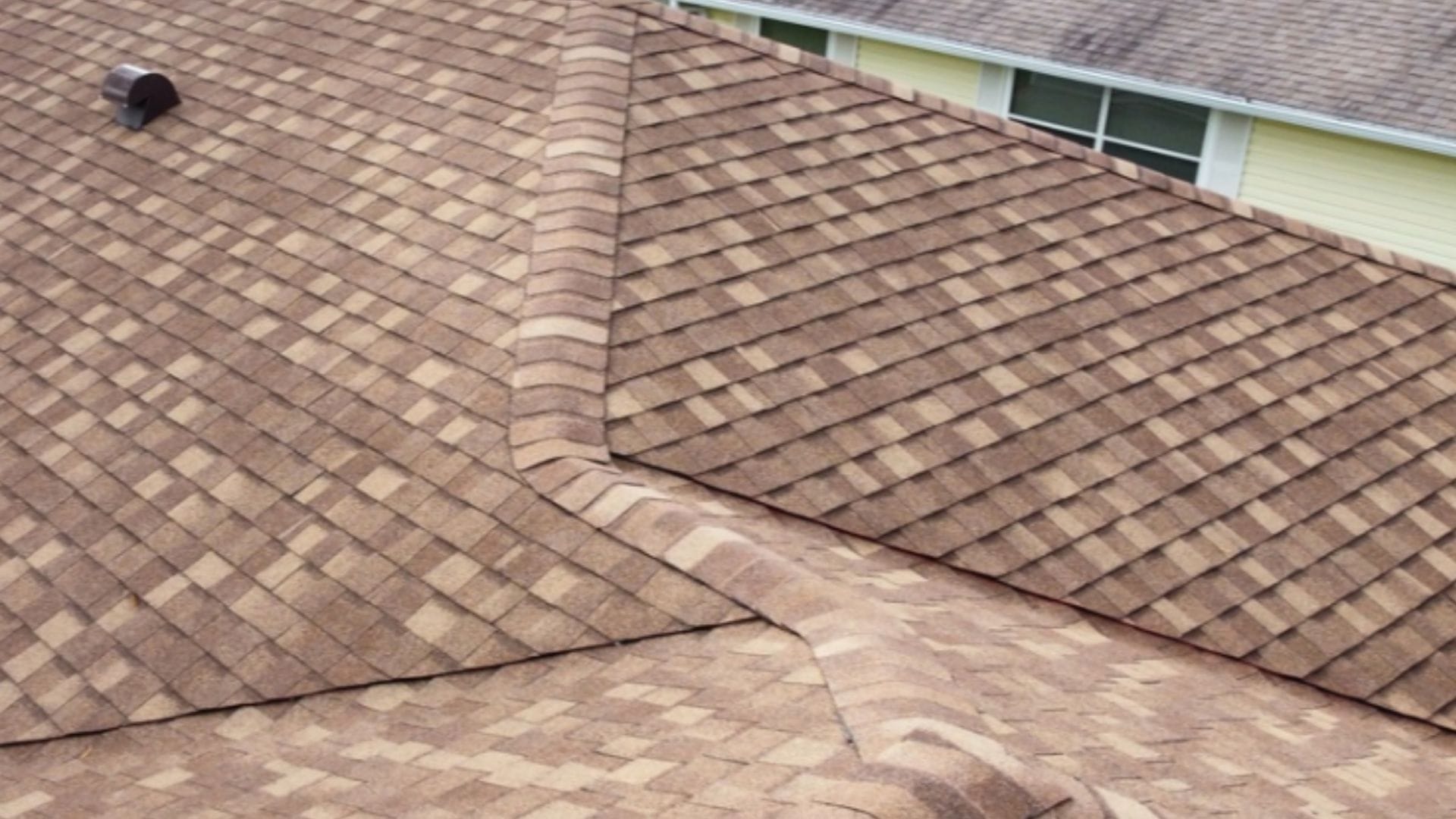 Roof inspection Tavares — roofing expert inspecting shingles on a Florida home after storm season.