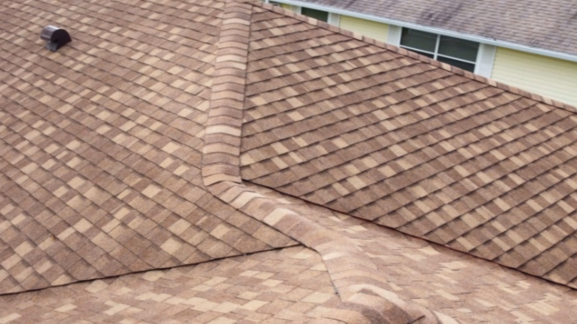 Roof inspection Tavares — roofing expert inspecting shingles on a Florida home after storm season.