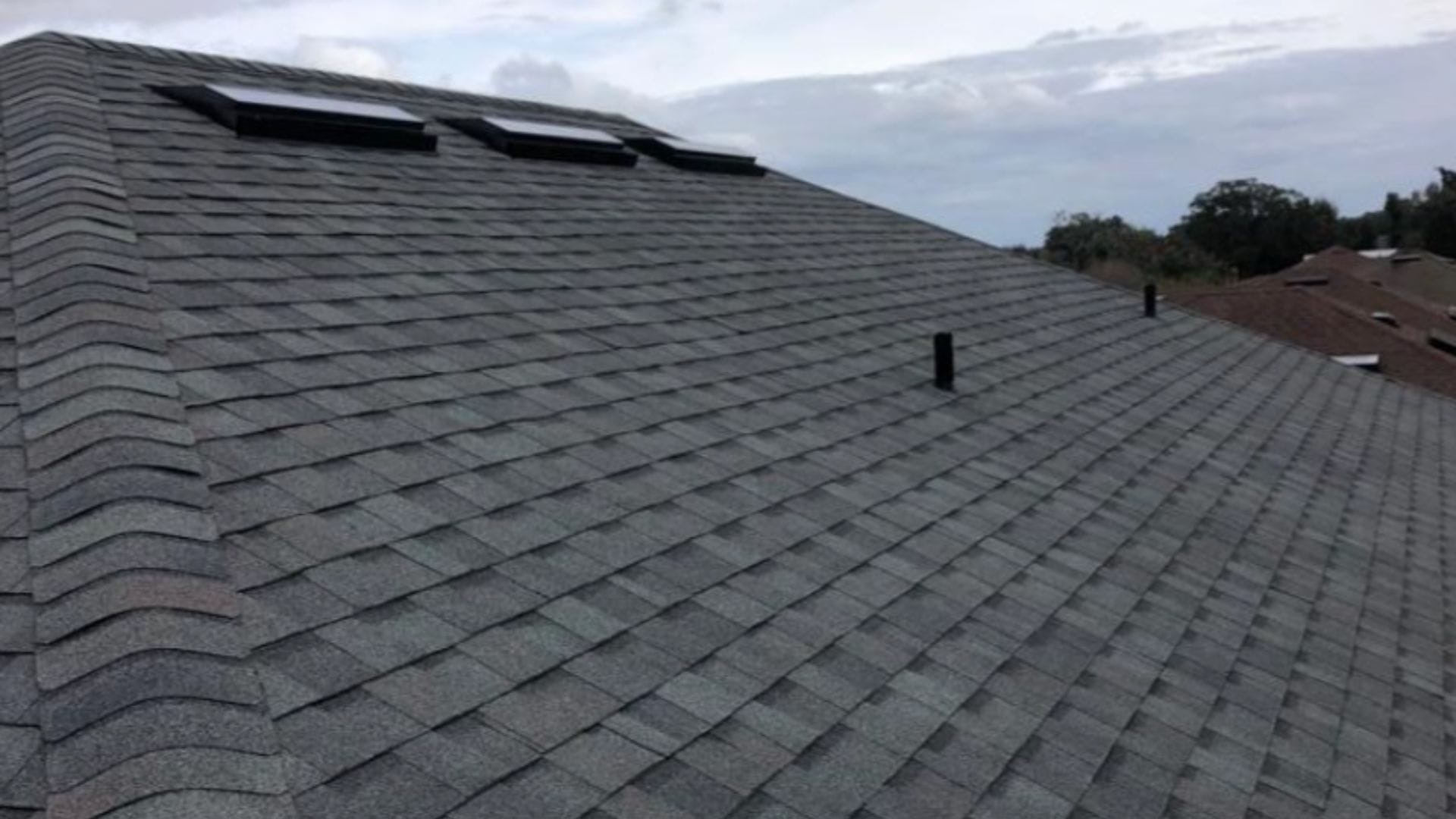 Roof inspection Winter Garden — roofing expert inspecting shingles on a Florida home after storm season.