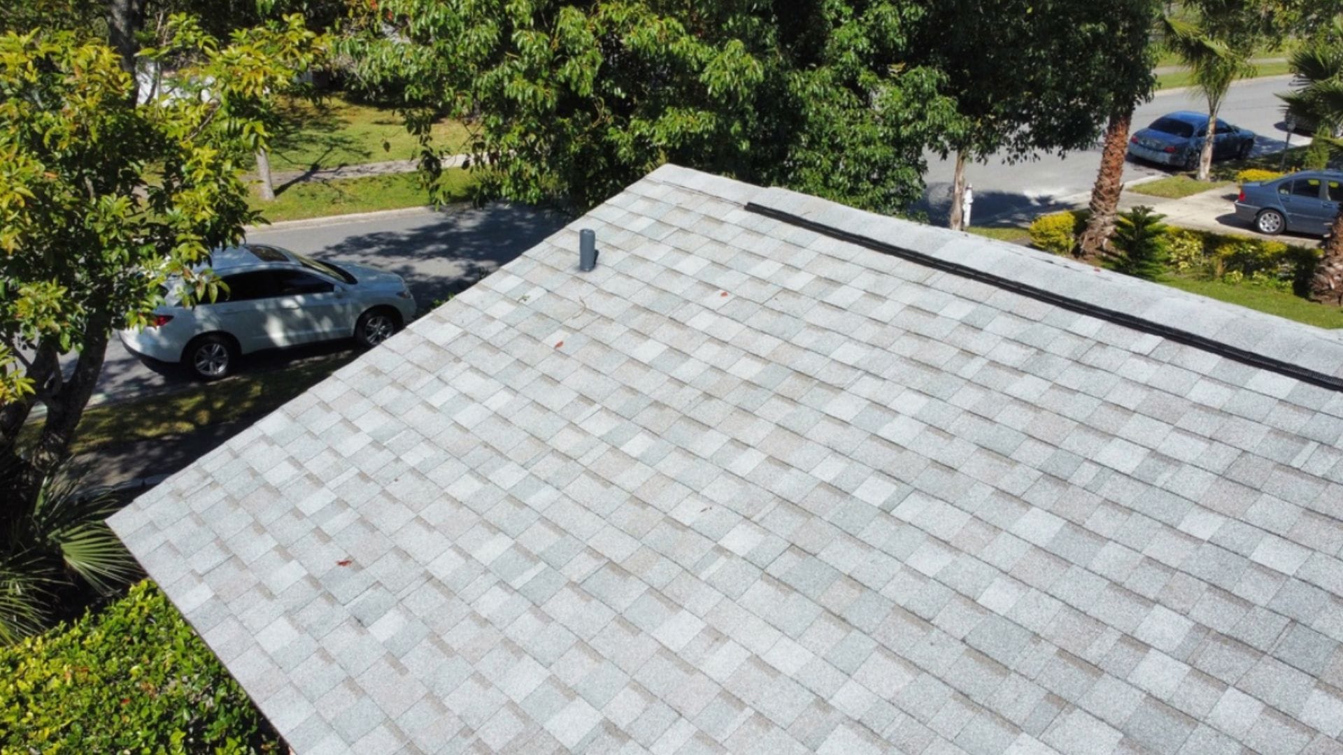 Roof inspection Altamonte Springs — roofing expert inspecting shingles on a Florida home after storm season.