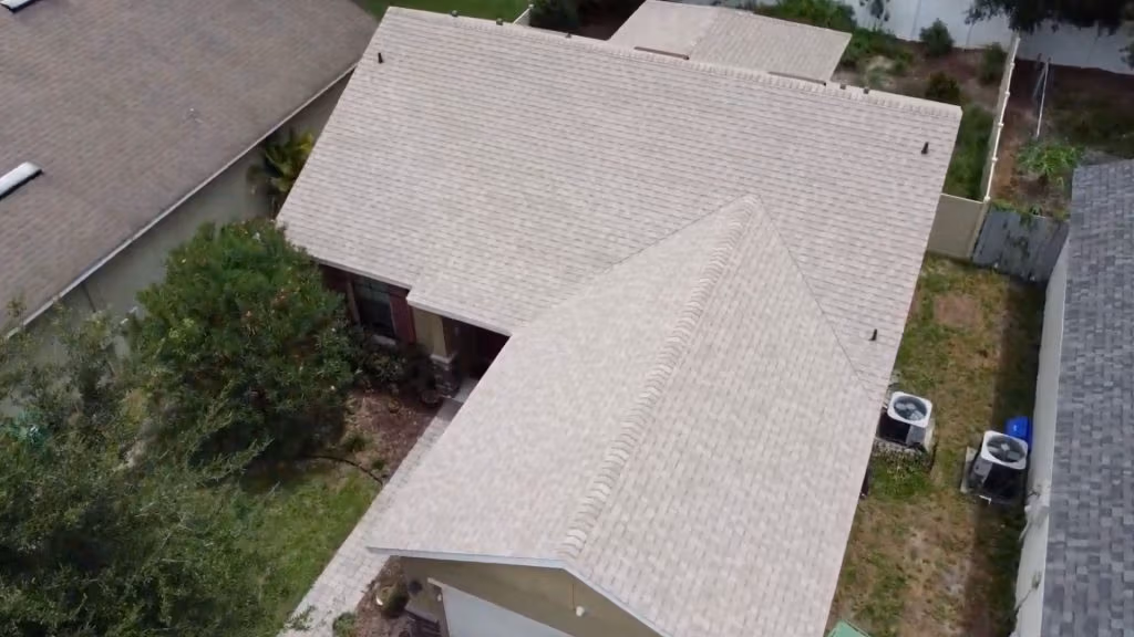 Roof inspection Deland — roofing expert inspecting shingles on a Florida home after storm season.
