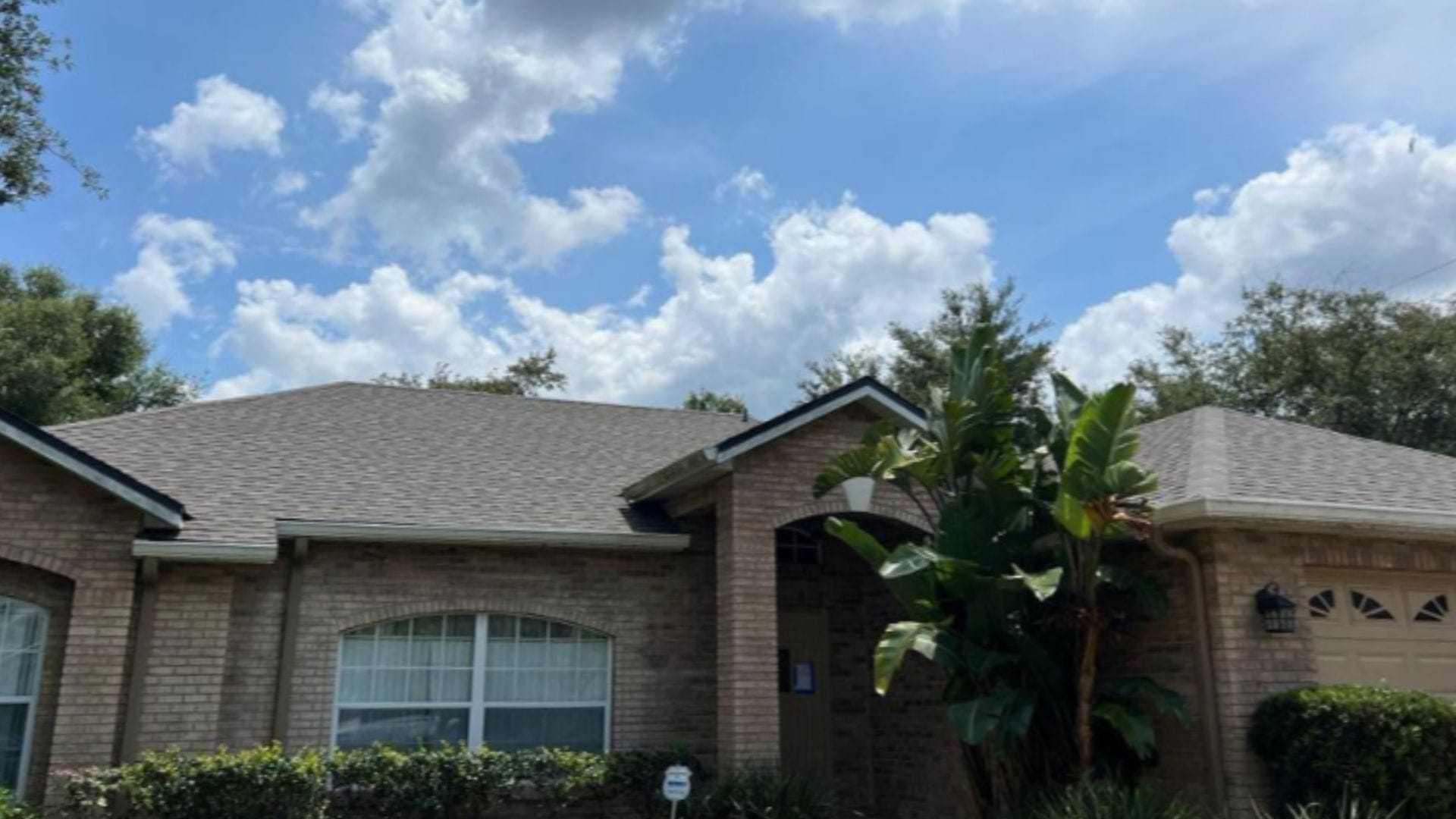 Roof inspection Deltona — roofing expert inspecting shingles on a Florida home after storm season.