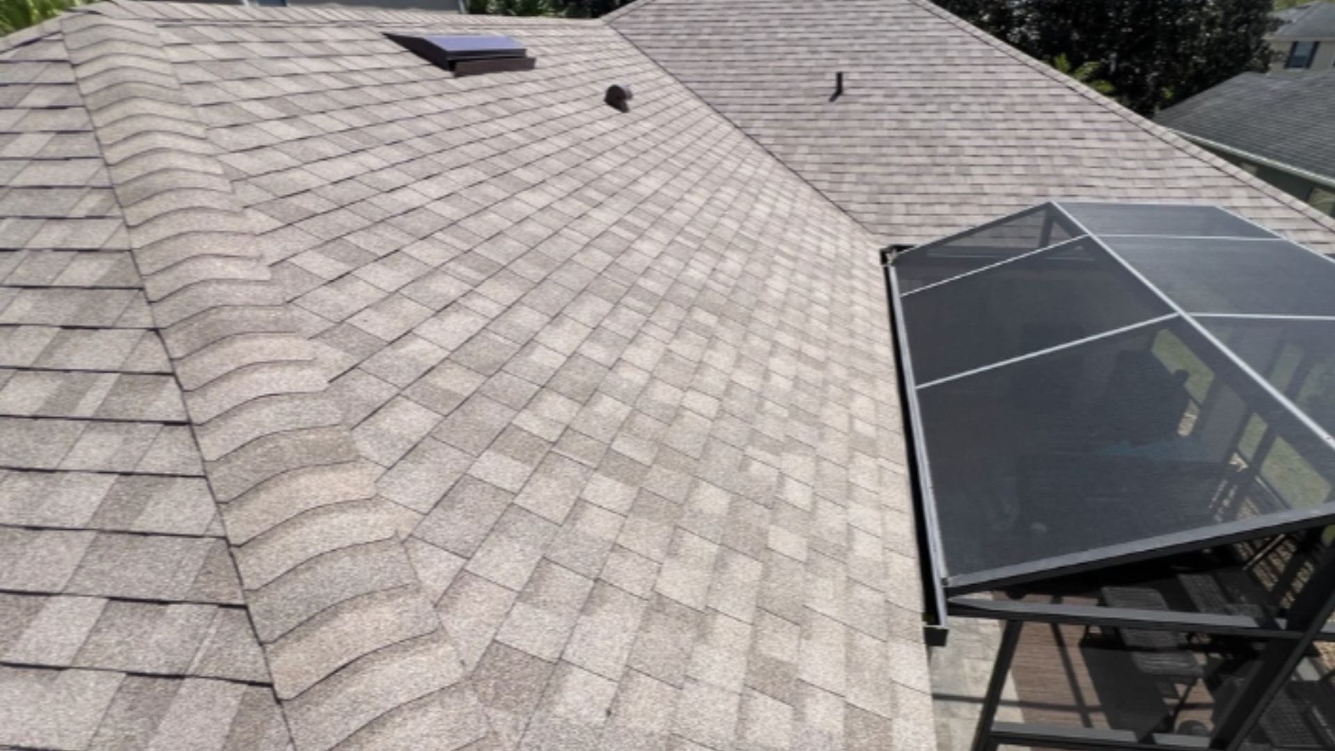 Roof inspection Apopka — roofing expert inspecting shingles on a Florida home after storm season.